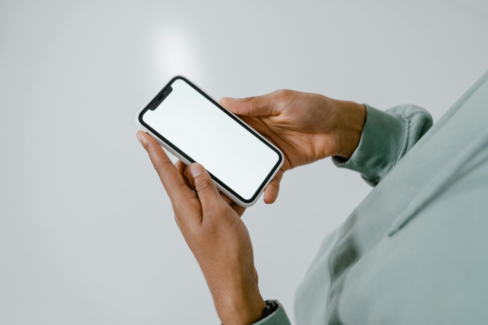 Hands holding a phone, dictating a voice memo