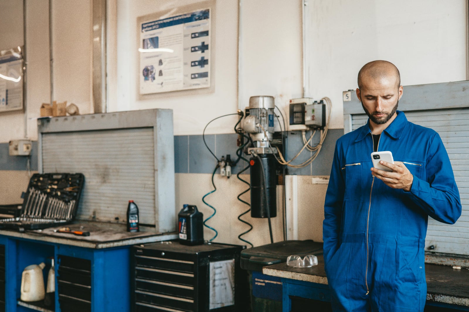Service business owner using a smartphone on the job