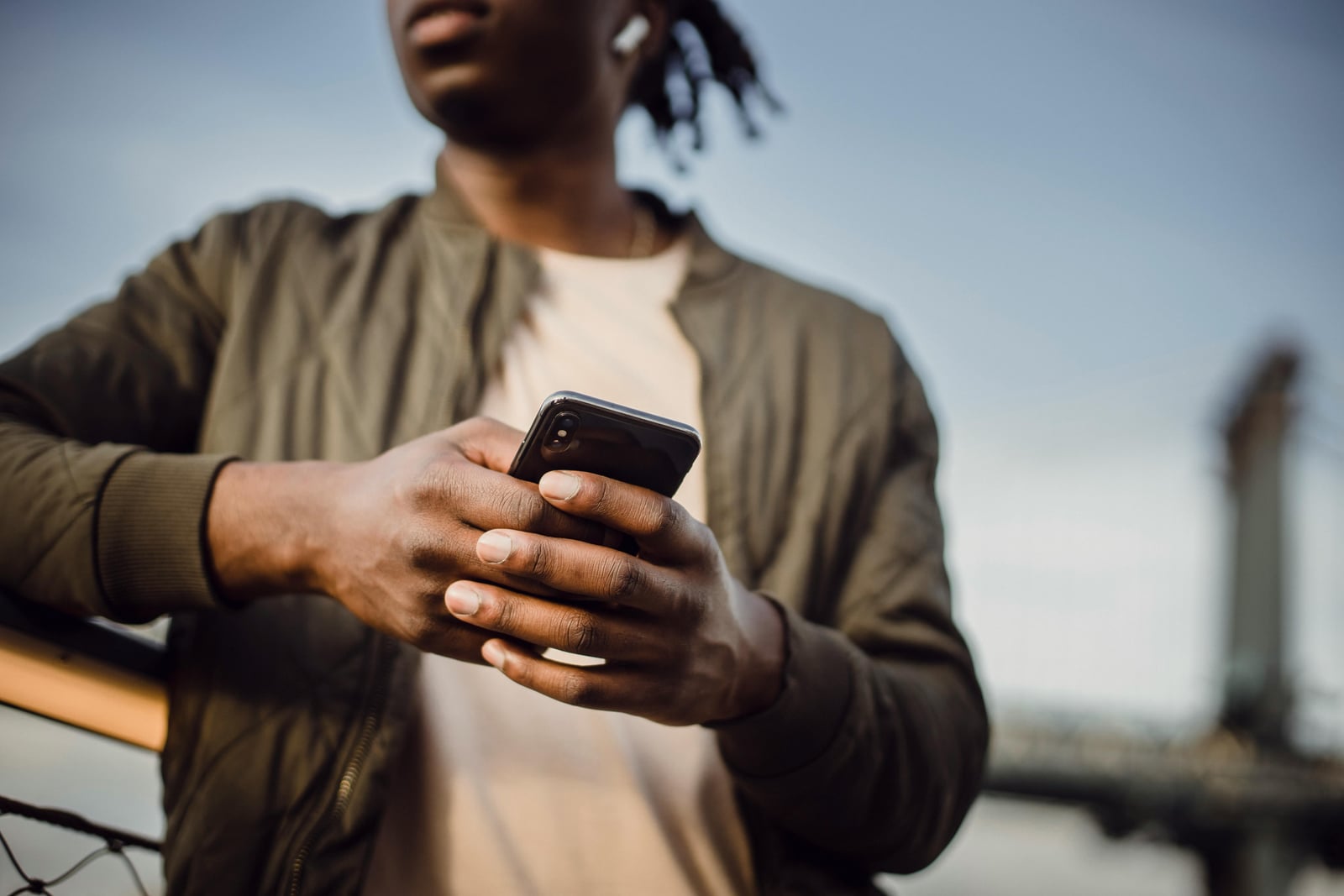 Black service business owner using a phone at work