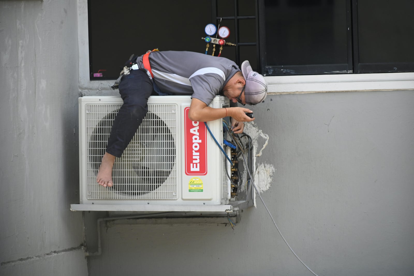 HVAC technician servicing an air conditioning unit